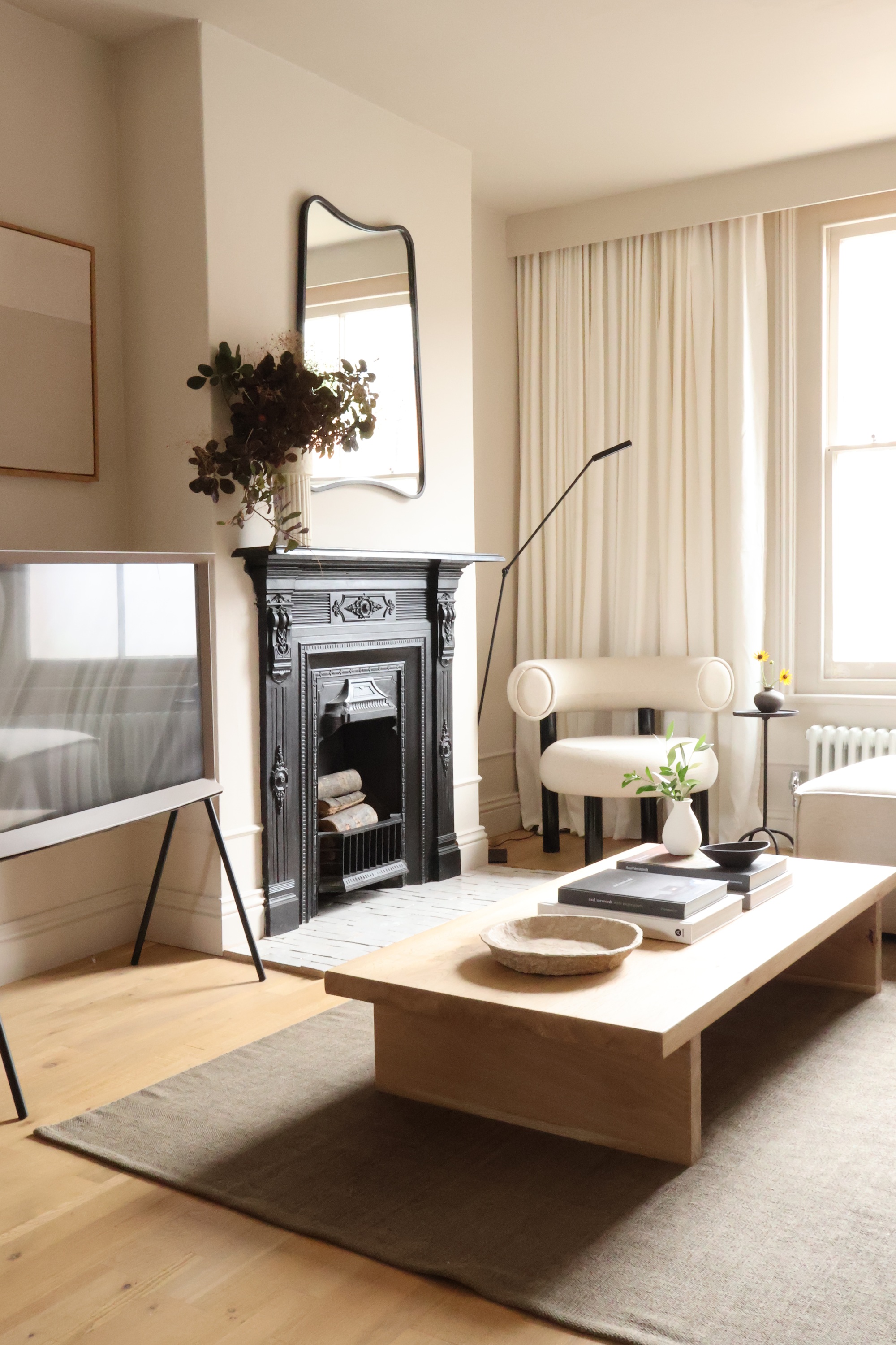a beige living room with a wood coffee table and light furniture