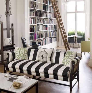 striped sofa in living area and book shelves