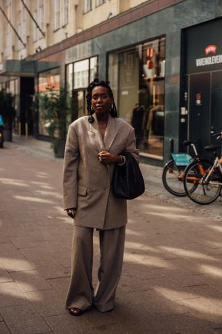 woman wearing tan suit set