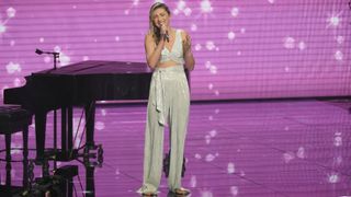 Allegra Miles performs on-stage next to a grand piano in the latest episode of American Idol.