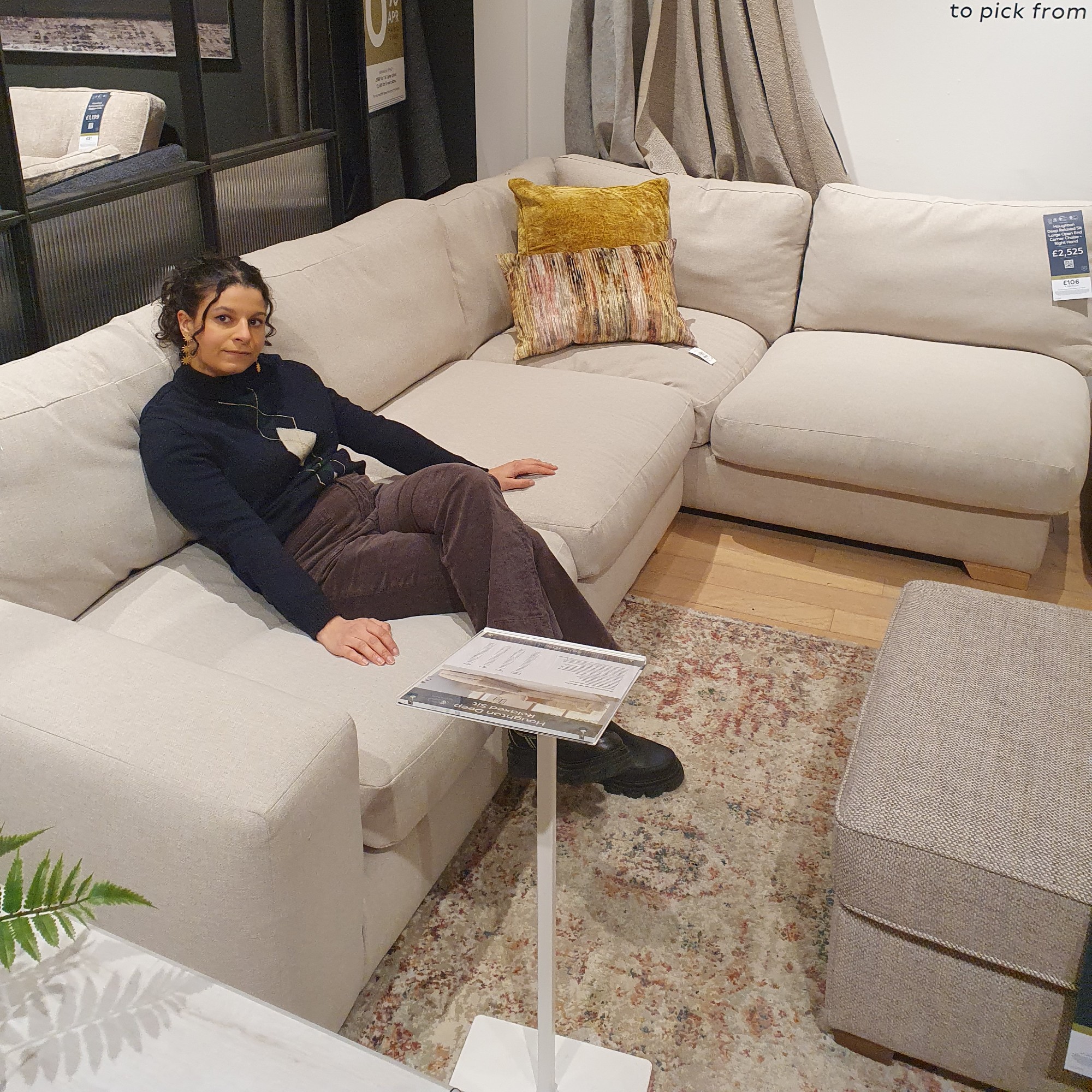 Sara sitting on a Next corner sofa