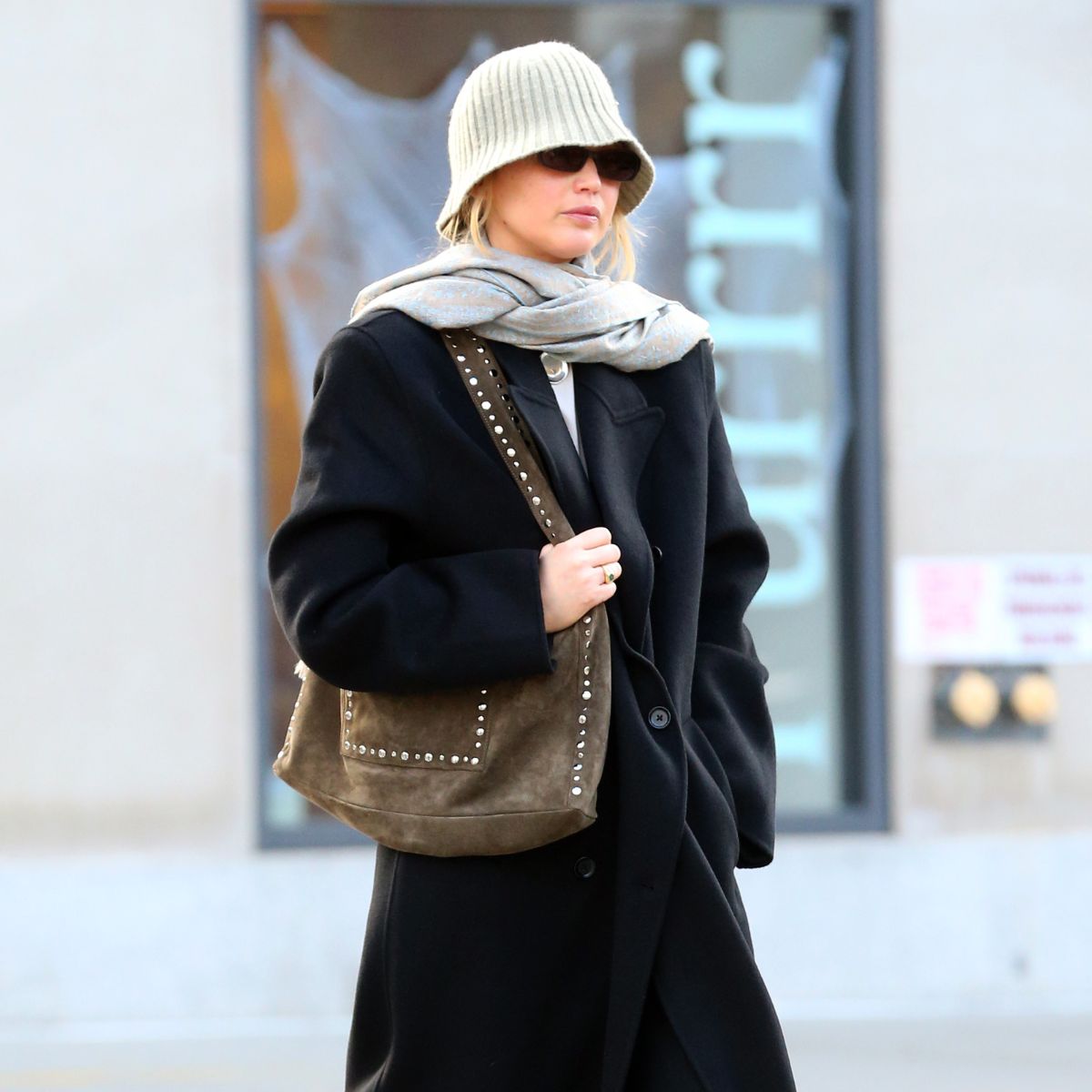An image of Jennifer Lawrence wearing a 90s romcom winter outfit.