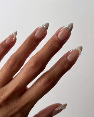 Bridal nails with pearl and bow designs