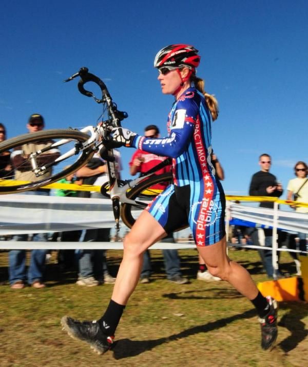 Katie Compton (Planet Bike) over the barriers.