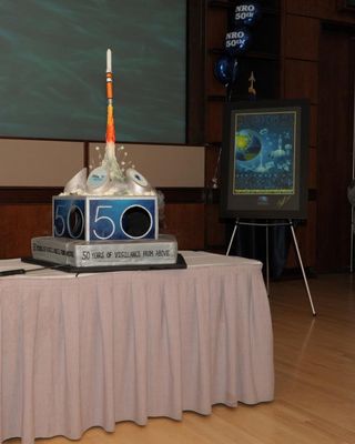 The National Reconnaissance Office's 50th Anniversary cake and commemorative poster to mark the Sept. 9 founding of the U.S. spy satellite agency.