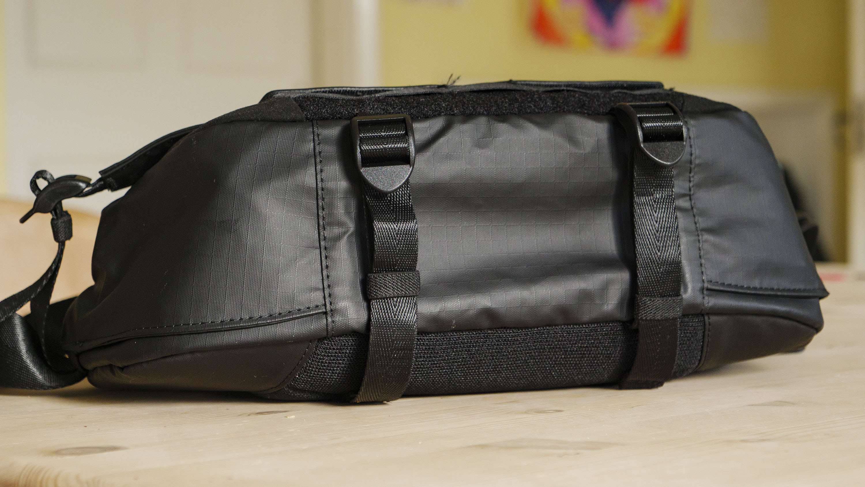 The Ulanzi Camera Sling Bag on a wooden table, underside