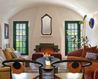 living room with curved roof, burnt orange sofa and statement furnishings