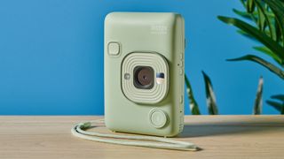 A matcha green Fujifilm Instax mini LiPlay 2-in-1 instant camera and printer