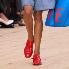Woman in red shoes and shorts