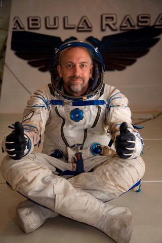 American computer game developer Richard Garriott gives a thumbs up in while wearing a Russian Sokol spacesuit during a weightless ride to celebrate the release of his new game 'Tabula Rasa.'