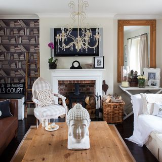 living room with fireplace and chandelier with statue