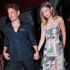 Gigi Hadid wearing a patchwork dress and silver shoes in NYC