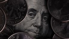 Ben Franklin on $100 bill surrounded by quarters