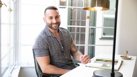 Carmine Sabatella sitting at a white desk