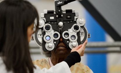 An eye examination is performed as part of a free health care service at the Care Harbor clinic at the Los Angeles Sports Arena in September 2012. 