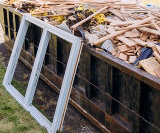 A window frame next to a skip