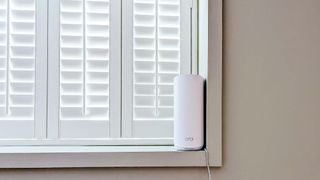 Netgear Orbi 873 on window ledge