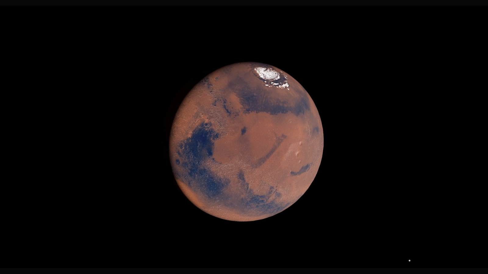 A close up of Mars shows its surface in outer space.