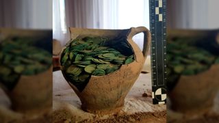 Archaeologists think the clay jug containing the horde of coins was deliberately buried on a farm in the east of Poland in the second half of the 17th century.