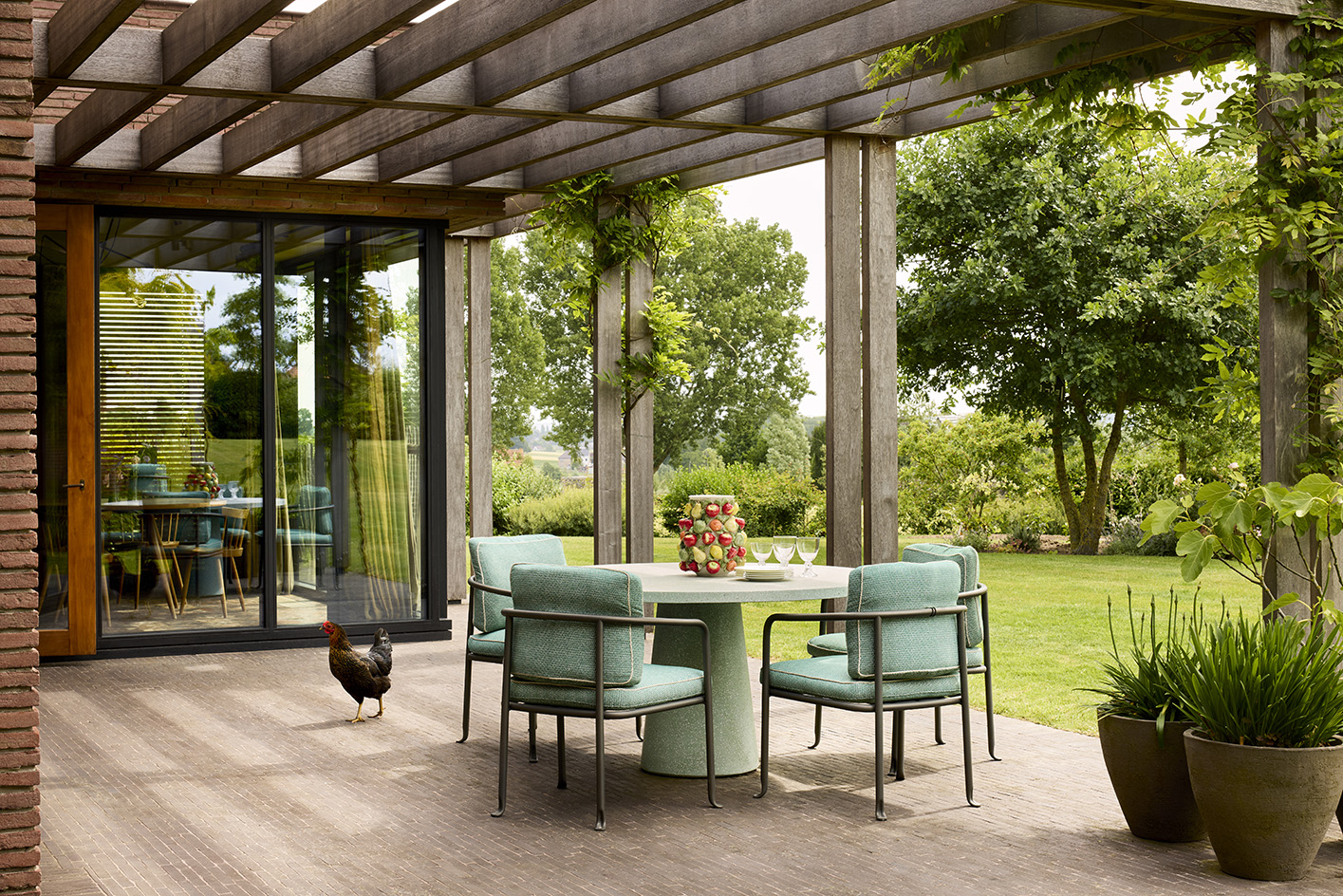 Flemish House by Julie Thiers, a brick house among greenery