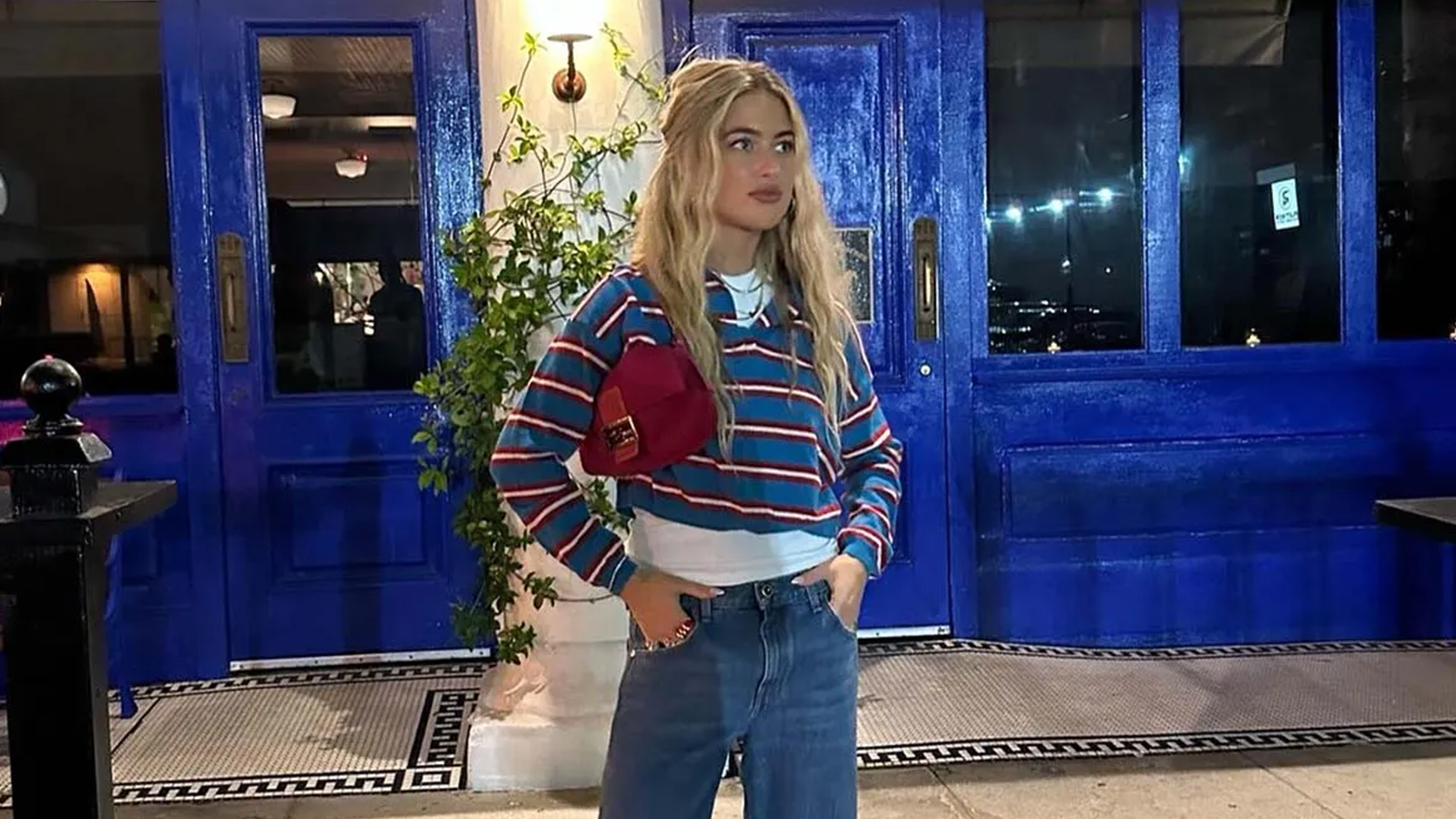 emili sindlev wearing a striped shirt and jeans