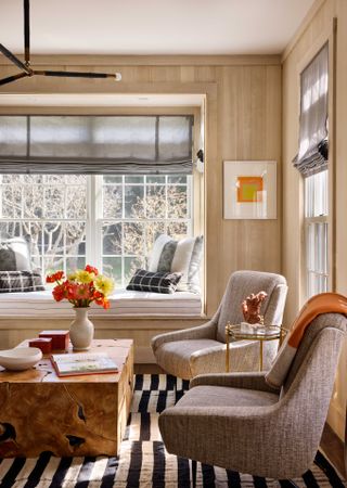 striped black and white rug in brown living room