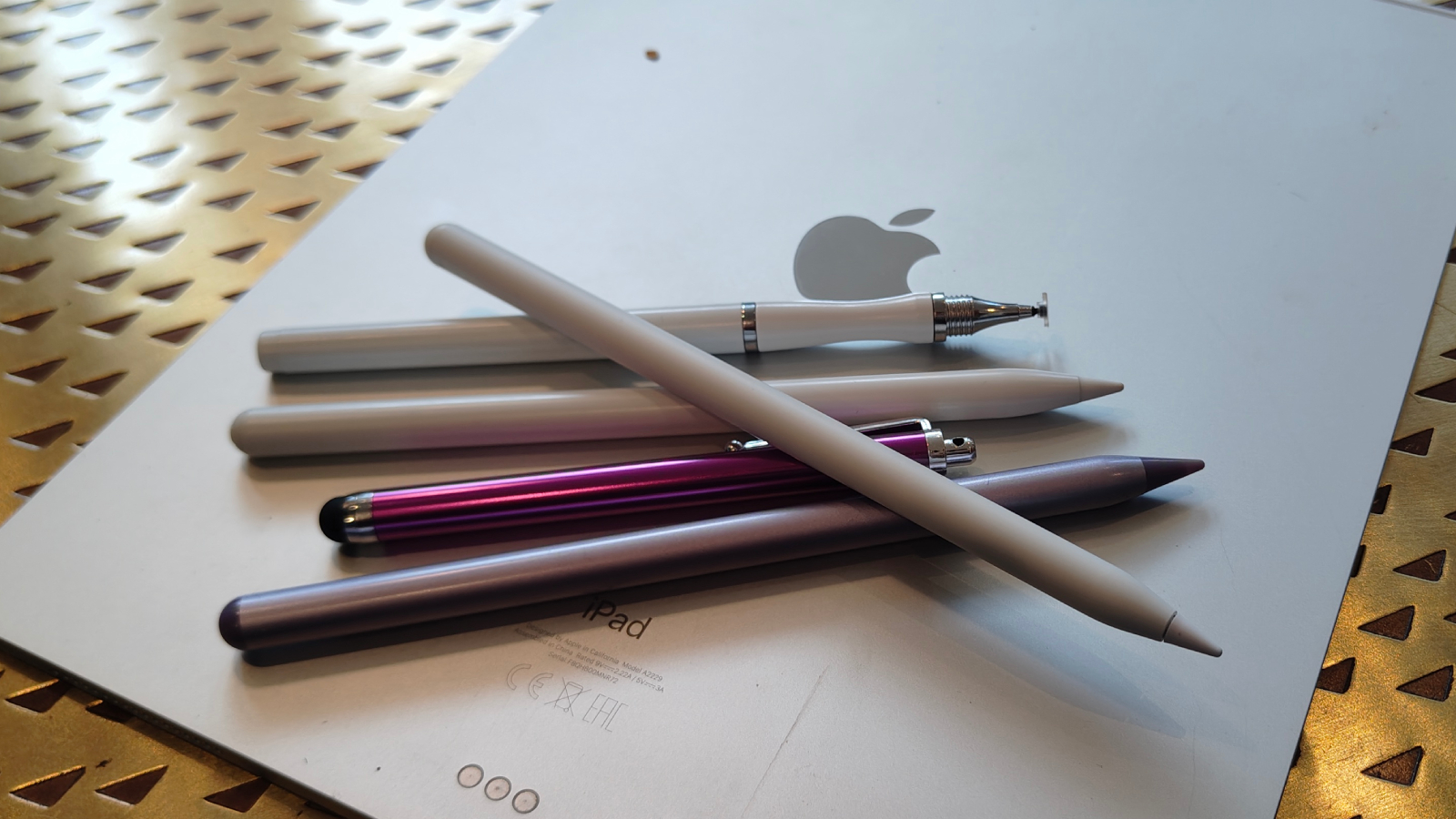 Several Apple Pencil alternatives on top of an iPad.