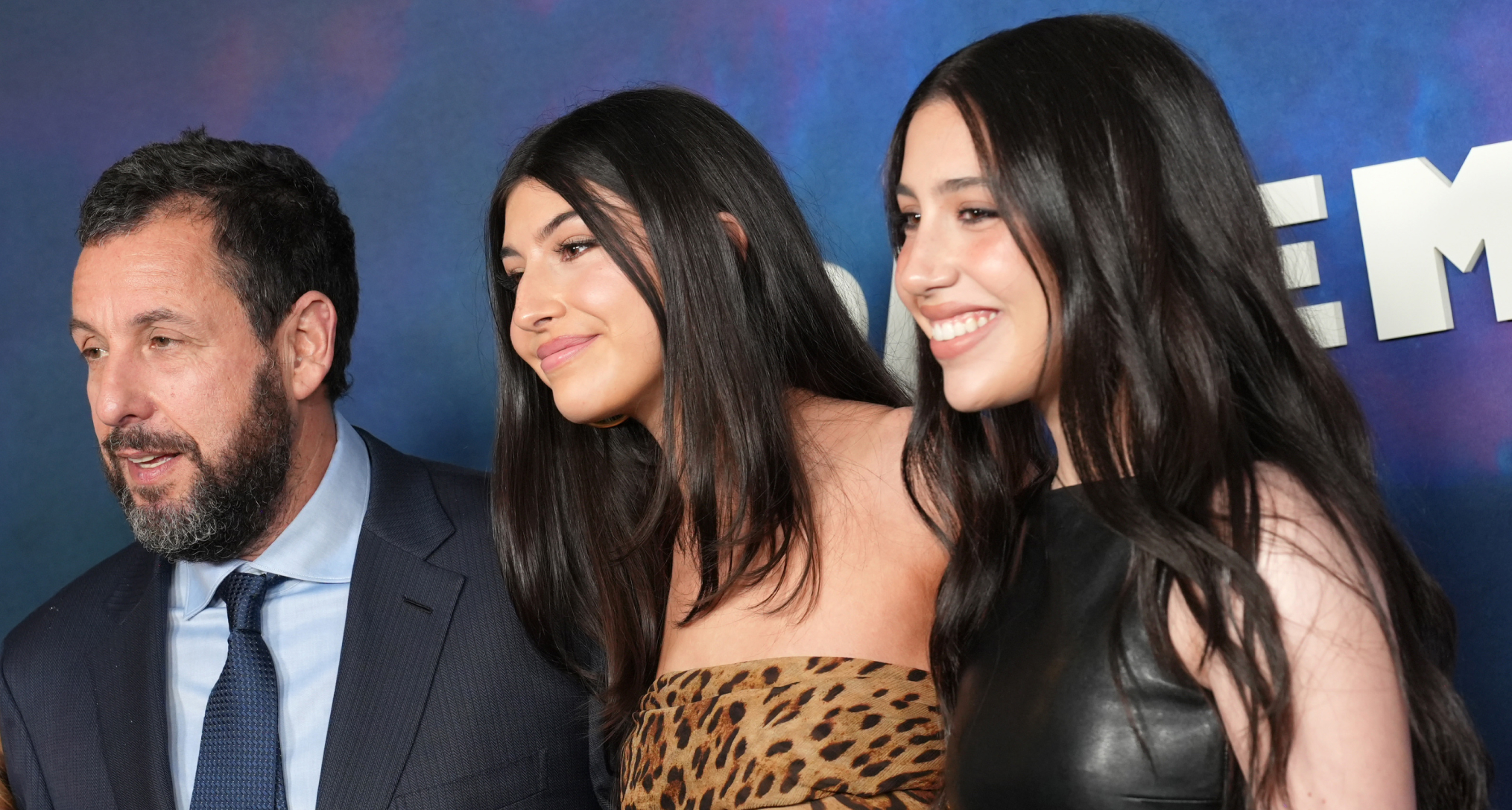 dam Sandler, Sunny Sandler and Sadie Sandler smiling on the red carpet for Netflix's "Spaceman" at The Egyptian Theatre Hollywood on February 26, 2024 in Los Angeles