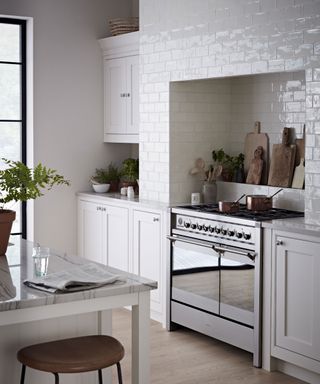 White kitchen with white wall tiles and a range cooker