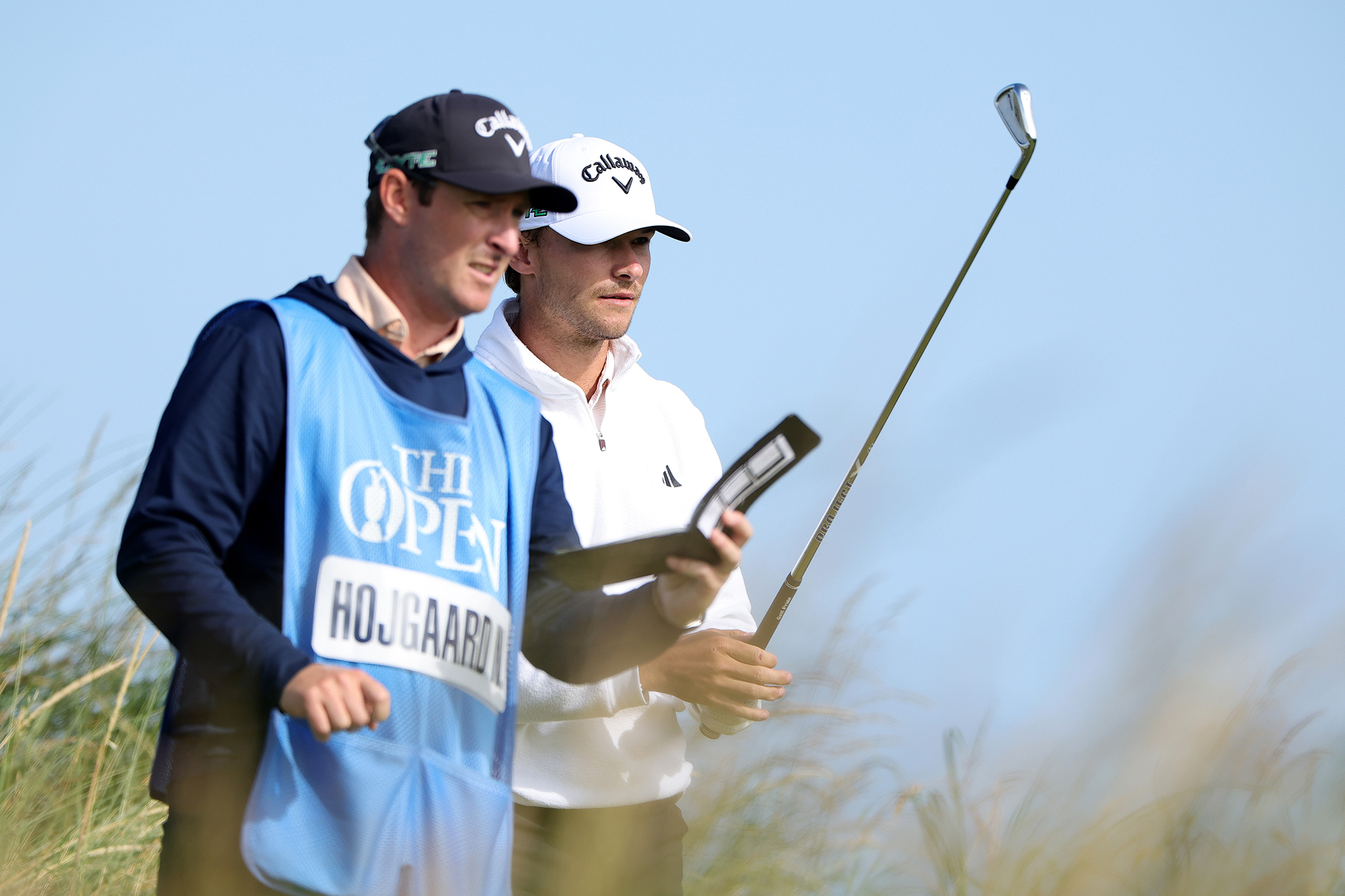 Nicolai Hojgaard talking to his caddie durin a practice round for the Open Championship at Royal Portrush