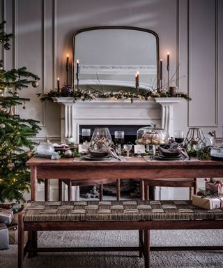 When should you start decorating for Christmas? Dining room with decorated dining table, fireplace, christmas tree