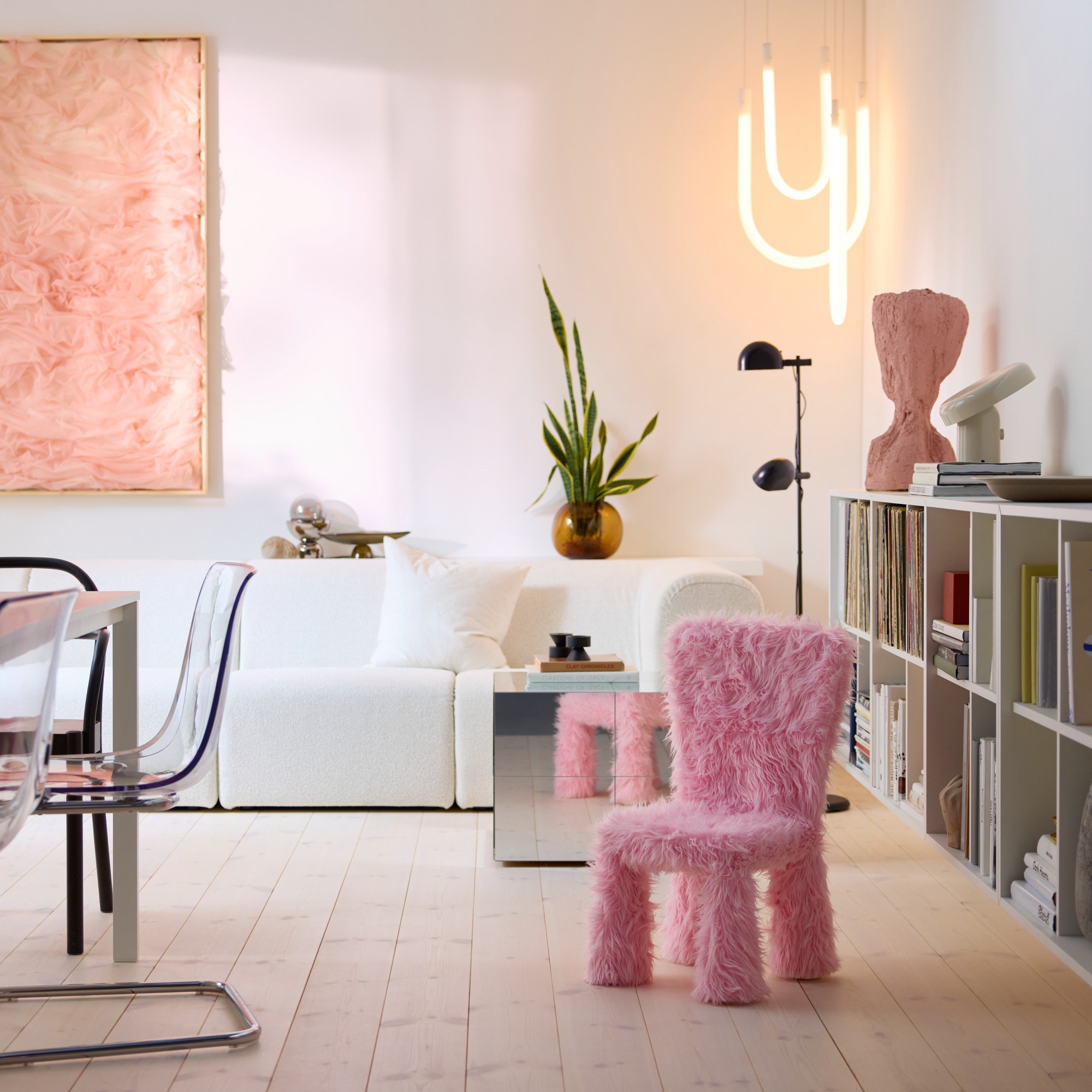 A modern minimalist living room with the IKEA MAMMUT kids&#039; chair covered in the brand&#039;s pink faux fur cover from the GREJSIMOJS collection
