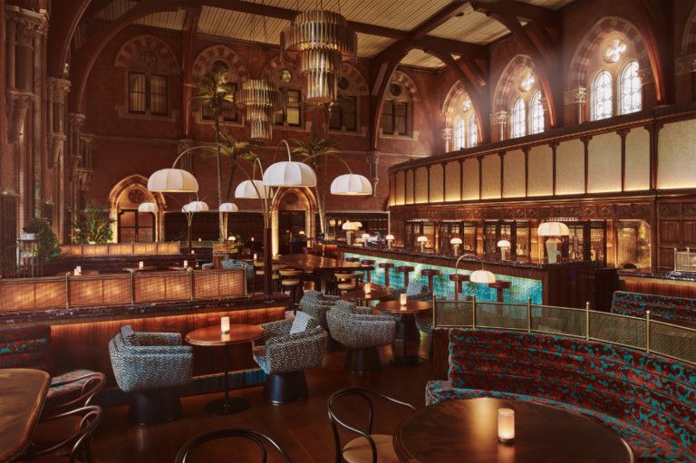 A vintage-inspired bar is captured at sunset with all of its beautiful wooden, glass, and paper-lantern decor being embraced by light.