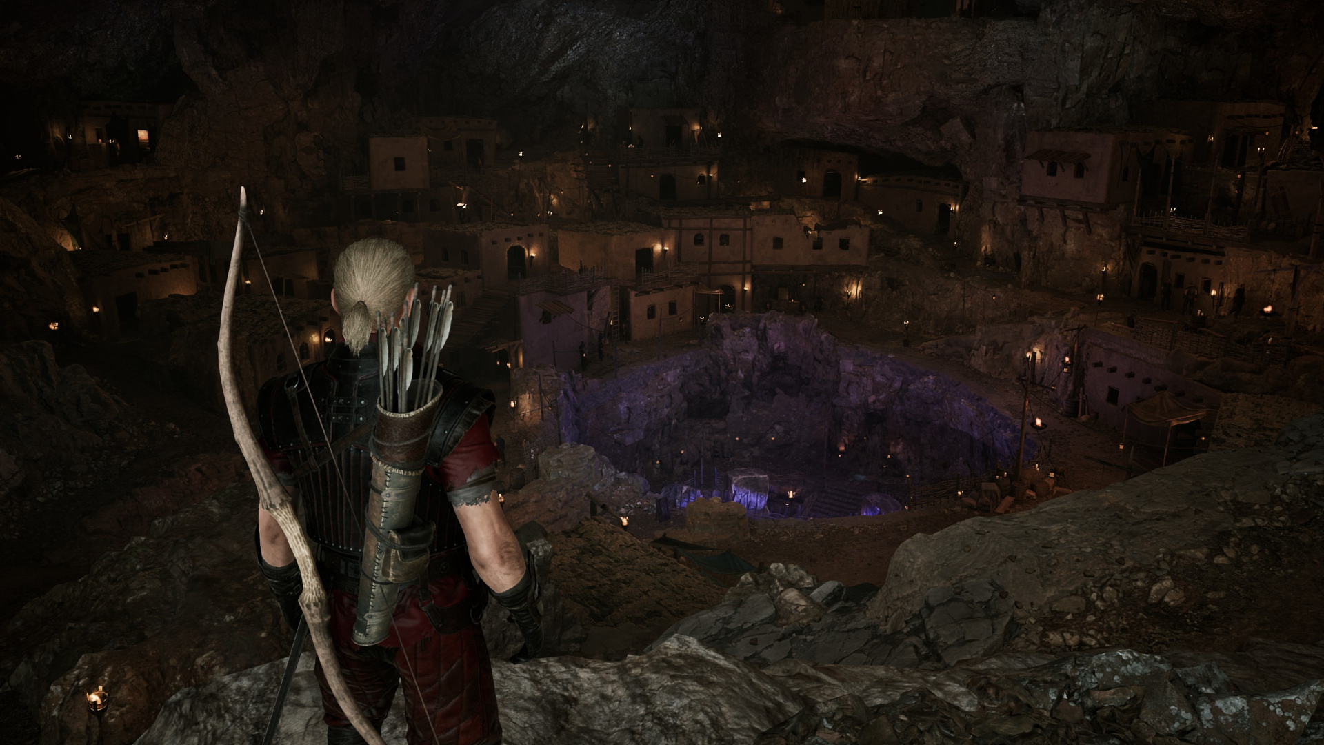 The player looks down across a mining pit in Gothic 1 Remake, dotted by flaming torches