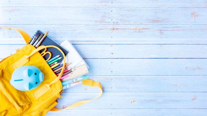 picture of childs yellow backpack with supplies for expanded child tax credit