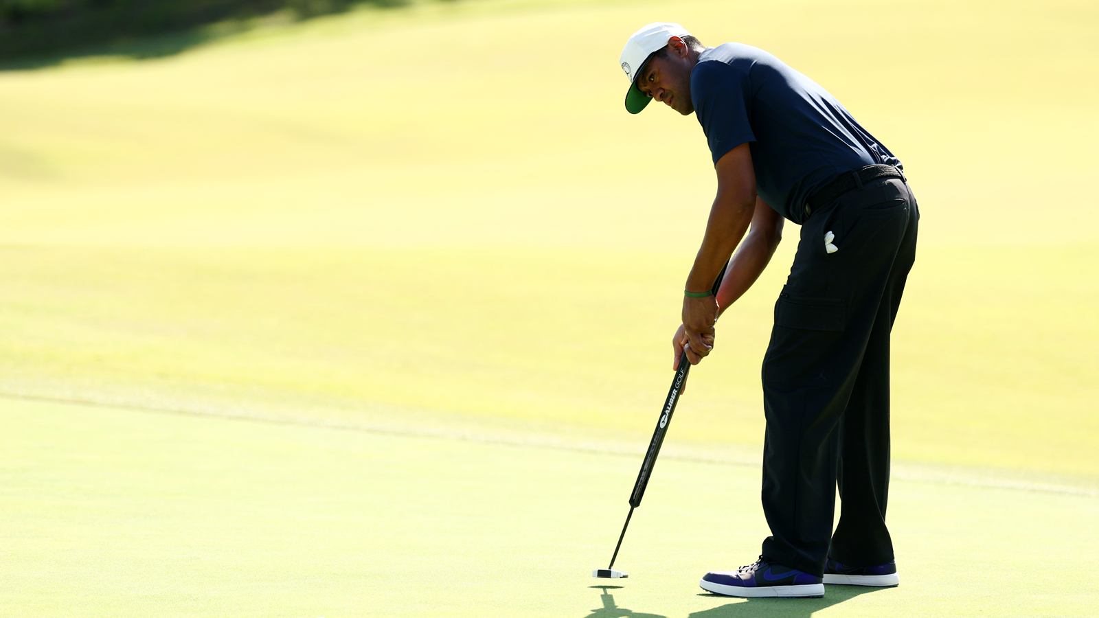Tony Finau hits a putt