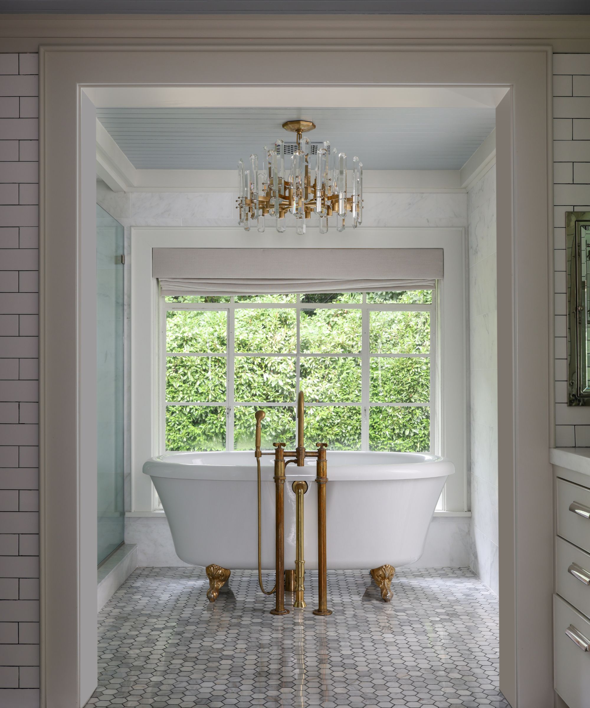 freestanding bath by window