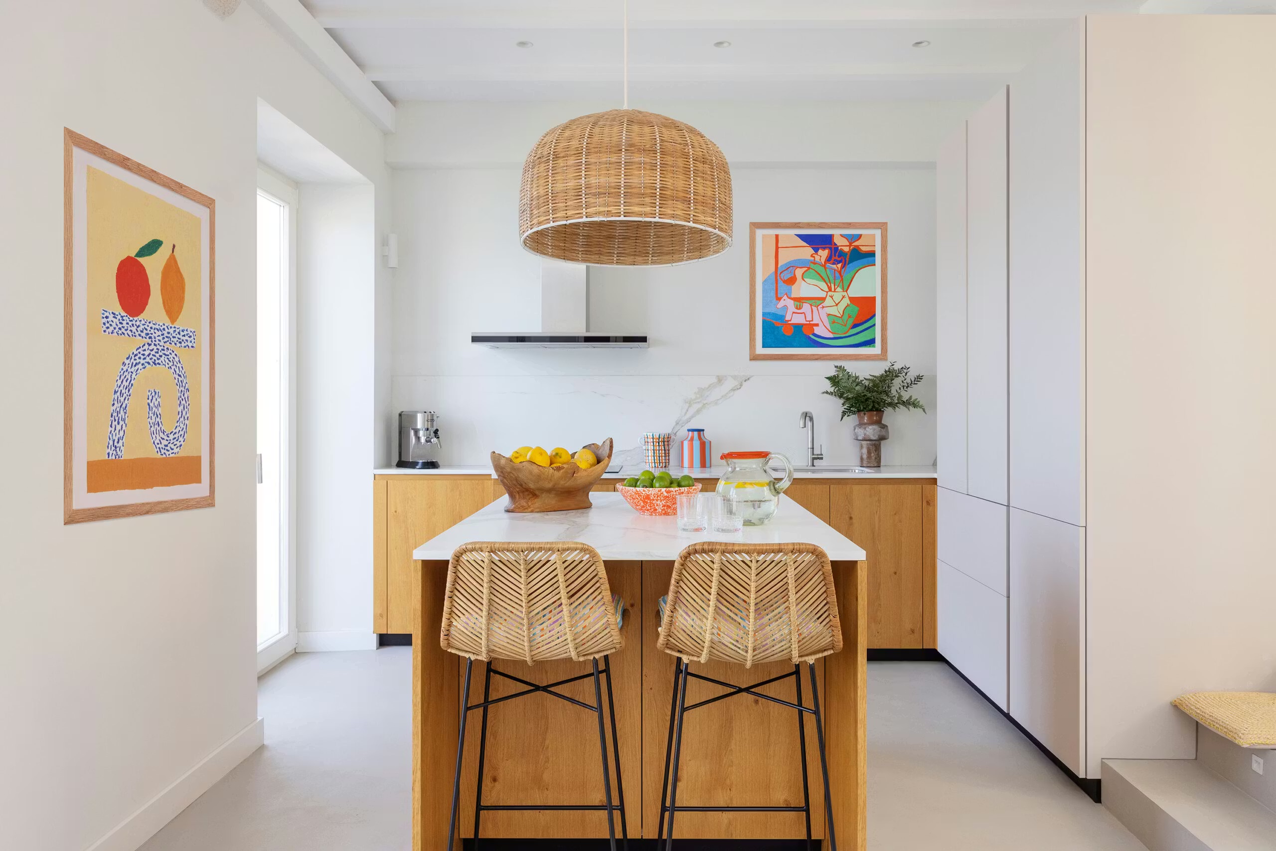 A kitchen with a large window to one side