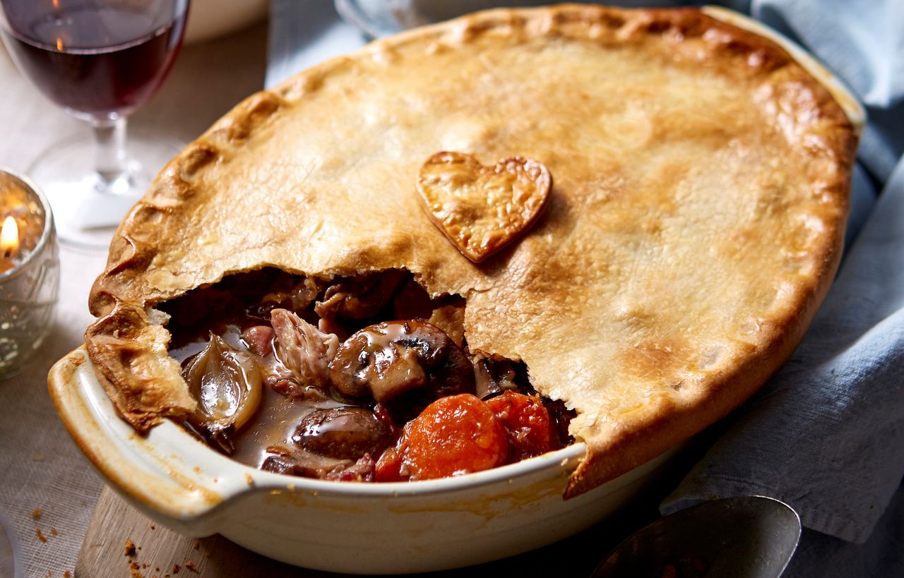 Coq au vin pie topped with golden pastry and a pastry love heart