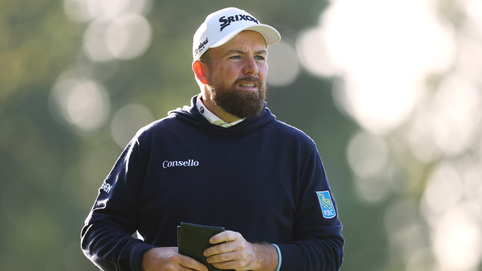 Shane Lowry walks off the green holding a yardage book