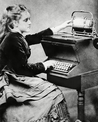 Lillian Scholes, daughter of Christopher, pictured in an 1872 photograph known as 'The First Typist'. Lillian was pictured using a prototype typewriter invented by her father, Christopher Latham Scholes.