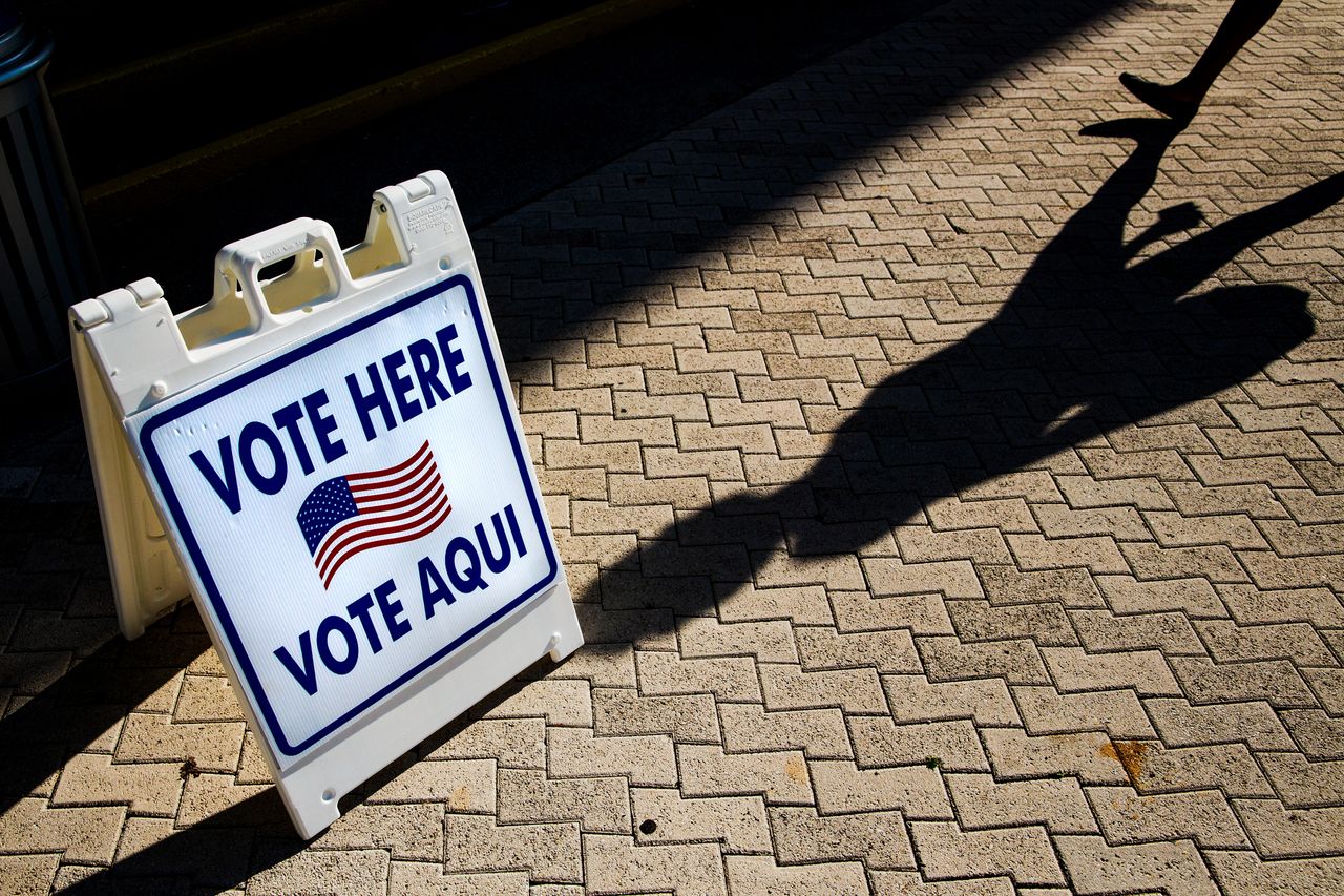 vote here directional sign photo