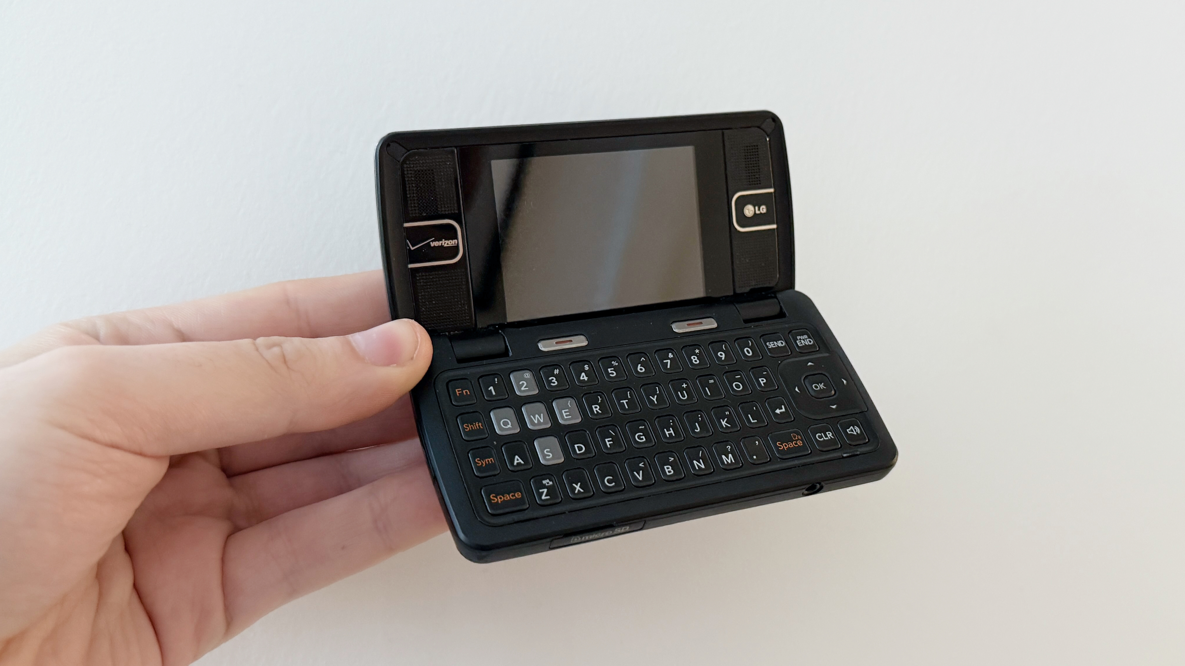 A hand holding the LG enV2 phone