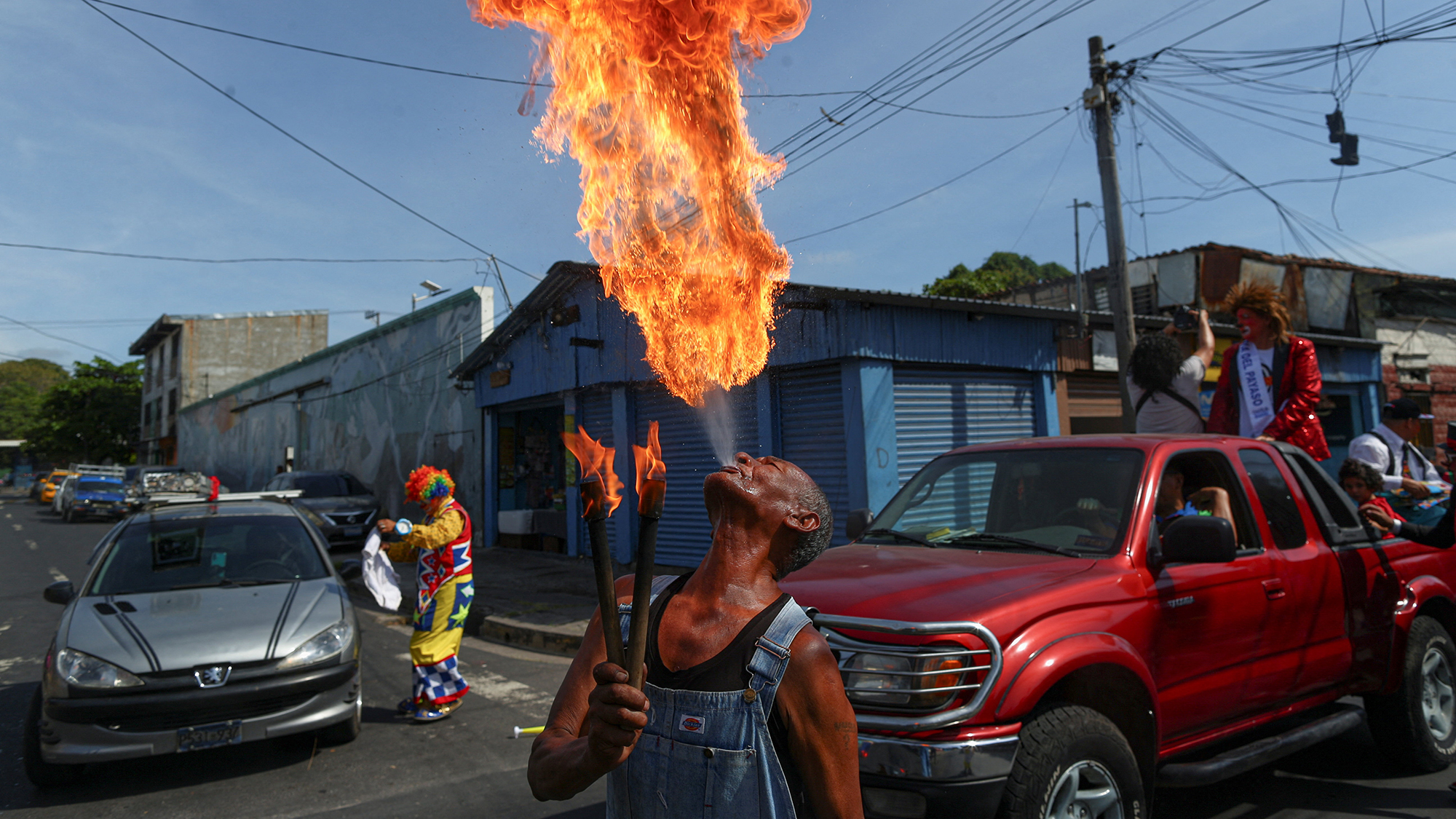 A fire breather performs during the National Clown Day parade in San Salvador, El Salvador
