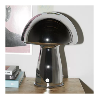 A silvery chrome mushroom lamp