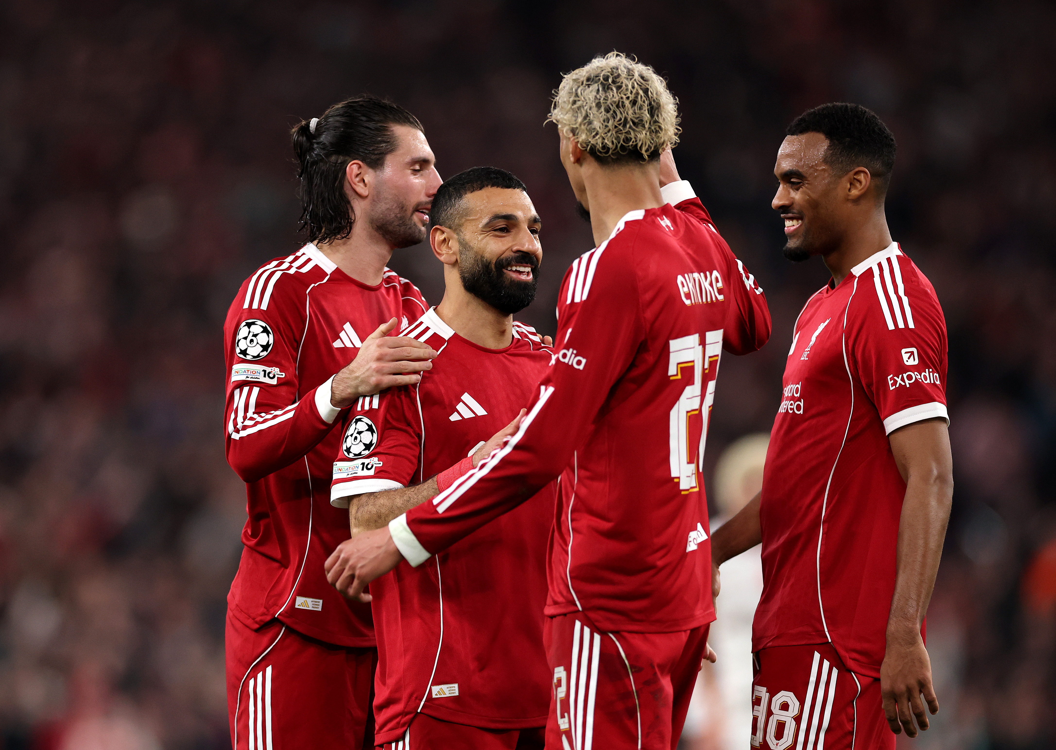 Mohamed Salah of Liverpool celebrates scoring his team's fourth goal with teammates Dominik Szoboszlai, Hugo Ekitike and Ryan Gravenberch during the UEFA Champions League 2025/26 Round of 16 Second Leg match between Liverpool FC and Galatasaray SK at Anfield on March 18, 2026 in Liverpool, England.