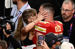 Taylor Swift kisses Kansas City Chiefs' tight end Travis Kelce after the Chiefs won Super Bowl LVIII.