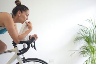 A woman training on a bike indoors