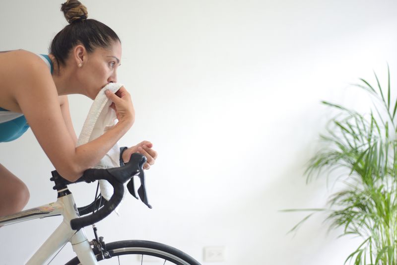 A woman training on a bike indoors