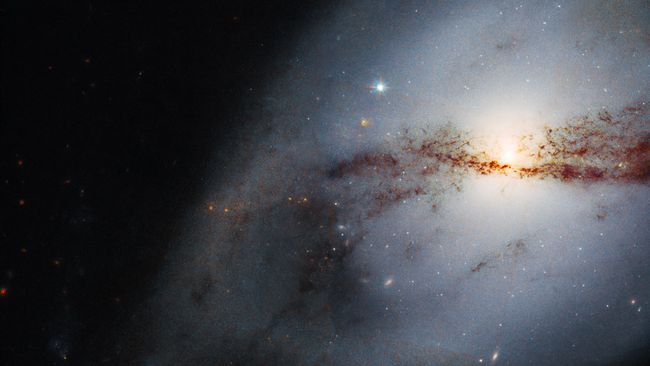 Hubble Space Telescope images twisted galaxy shaped by a big neighbor ...